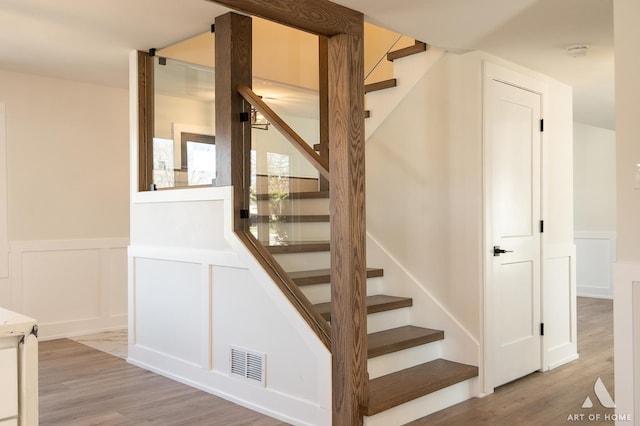 9859 S 81st Ave, Palos Hills, IL 60465 - stairway featuring wood finished floors, a wainscoted wall, and a decorative wall