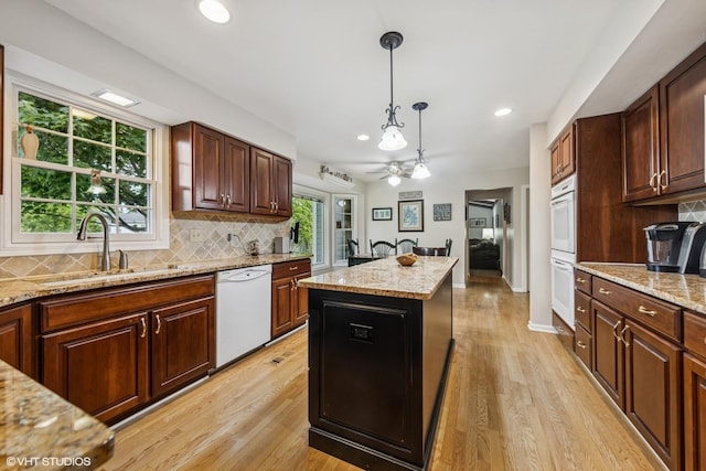 2139 Riverlea Cir, Naperville, IL 60565 - kitchen featuring white appliances, tasteful backsplash, decorative light fixtures, ceiling fan, and light wood-style floors