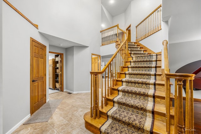 2734 Alyssa Dr, Naperville, IL 60565 - staircase featuring a high ceiling and tile patterned floors