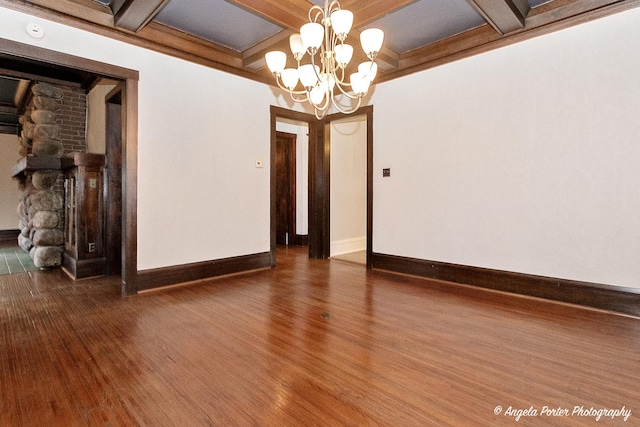 704 N Division St, Harvard, IL 60033 - spare room with wood finished floors, a chandelier, coffered ceiling, baseboards, and beamed ceiling