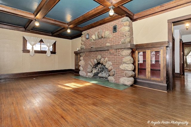 704 N Division St, Harvard, IL 60033 - unfurnished living room featuring wood finished floors, beam ceiling, coffered ceiling, baseboards, and a fireplace