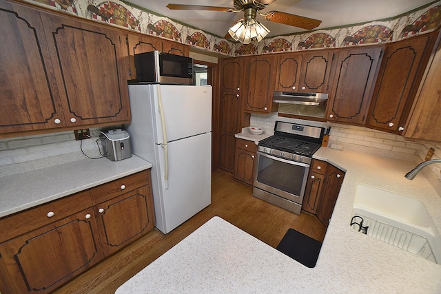 731 Marcy St, Ottawa, IL 61350 - kitchen featuring gas range, freestanding refrigerator, range hood, a sink, and light countertops