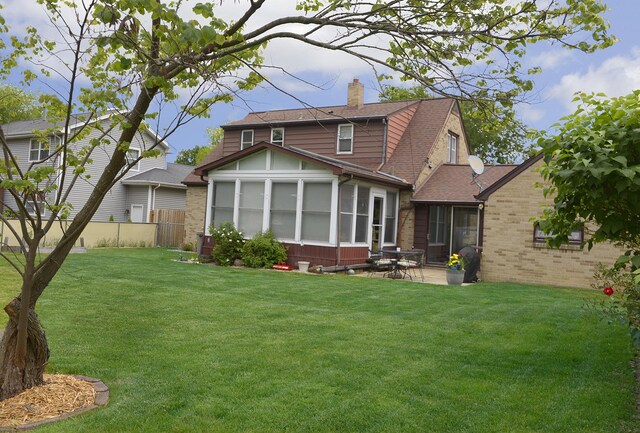 731 Marcy St, Ottawa, IL 61350 - back of house featuring a sunroom, a chimney, a patio area, brick siding, and roof with shingles