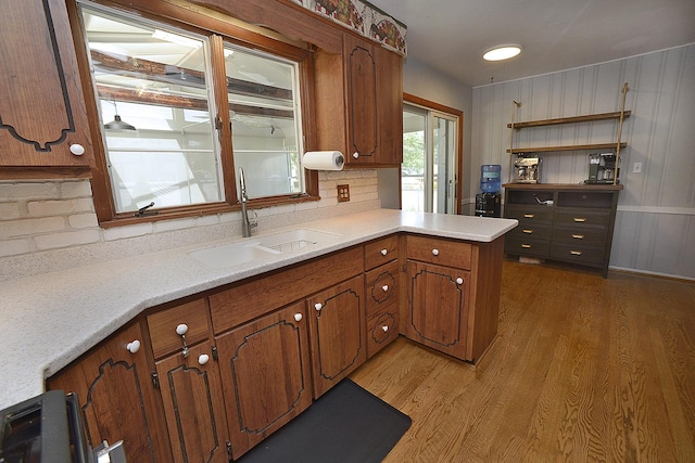 731 Marcy St, Ottawa, IL 61350 - kitchen with a sink, light wood-type flooring, light countertops, brown cabinetry, and a peninsula
