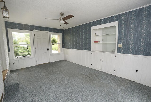 731 Marcy St, Ottawa, IL 61350 - empty room with wainscoting, a ceiling fan, wallpapered walls, a textured ceiling, and ornamental molding
