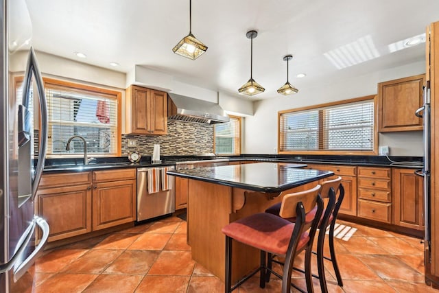 8252 N Caldwell Ave, Niles, IL 60714 - kitchen featuring appliances with stainless steel finishes, wall chimney range hood, plenty of natural light, brown cabinetry, and recessed lighting