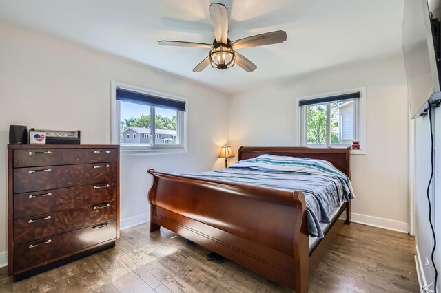 1360 Gentry Rd, Hoffman Estates, IL 60169 - bedroom featuring multiple windows, baseboards, wood finished floors, and a ceiling fan