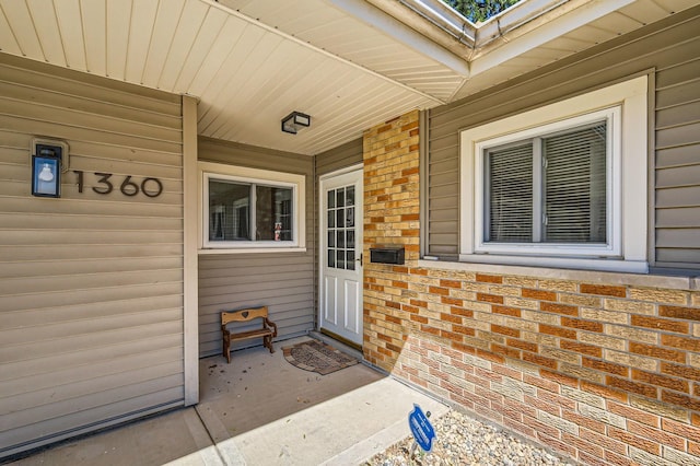 1360 Gentry Rd, Hoffman Estates, IL 60169 - view of exterior entry with covered porch and brick siding