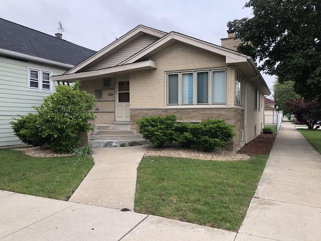 6100 S Parkside Ave, Chicago, IL 60638 - bungalow-style home with brick siding, a front lawn, and a chimney