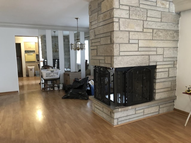 6100 S Parkside Ave, Chicago, IL 60638 - living area featuring a fireplace, wood finished floors, a chandelier, baseboards, and crown molding