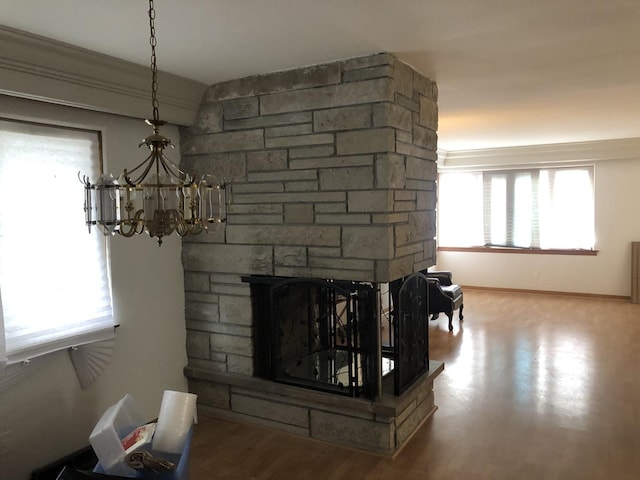 6100 S Parkside Ave, Chicago, IL 60638 - detailed view of a fireplace, a chandelier, wood finished floors, and baseboards