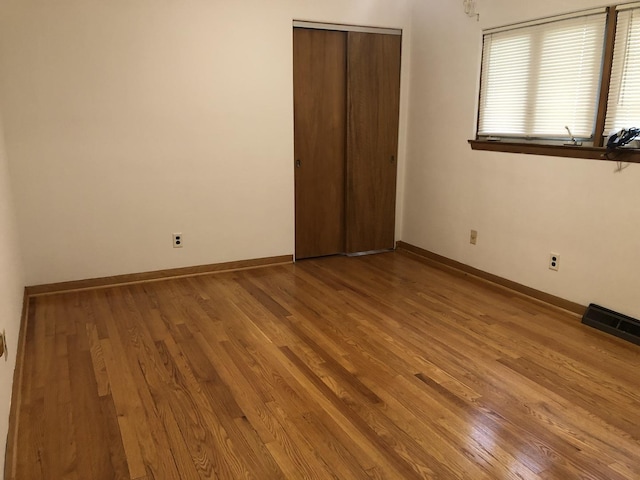 6100 S Parkside Ave, Chicago, IL 60638 - unfurnished bedroom featuring wood finished floors, baseboards, and a closet