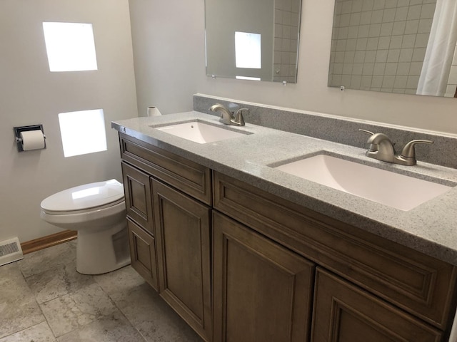 6100 S Parkside Ave, Chicago, IL 60638 - bathroom featuring double vanity, toilet, and baseboards