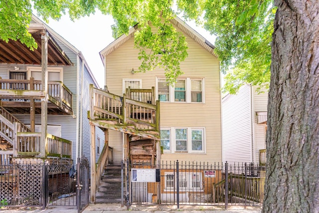 8711 S Exchange Ave, Chicago, IL 60617 - back of house featuring a gate and stairway