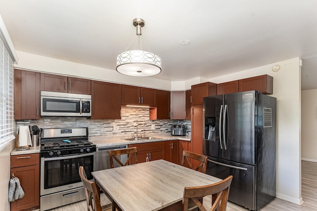 19011 John Ave, Country Club Hills, IL 60478 - kitchen with stainless steel appliances, a sink, light countertops, decorative backsplash, and light wood finished floors