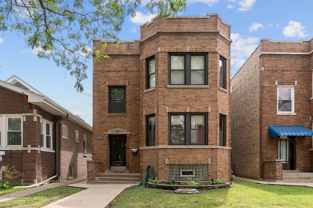 4109 W Oakdale Ave, Chicago, IL 60641 - view of front of home featuring brick siding and a front lawn