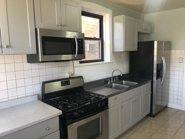 4109 W Oakdale Ave, Chicago, IL 60641 - kitchen with appliances with stainless steel finishes, a sink, light tile patterned flooring, crown molding, and backsplash