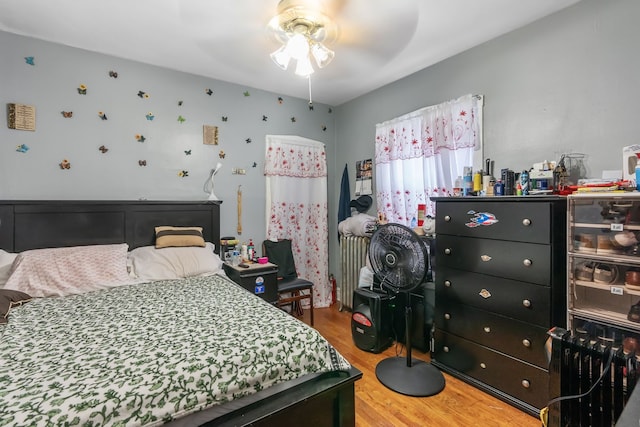 4109 W Oakdale Ave, Chicago, IL 60641 - bedroom featuring wood finished floors, radiator heating unit, and ceiling fan
