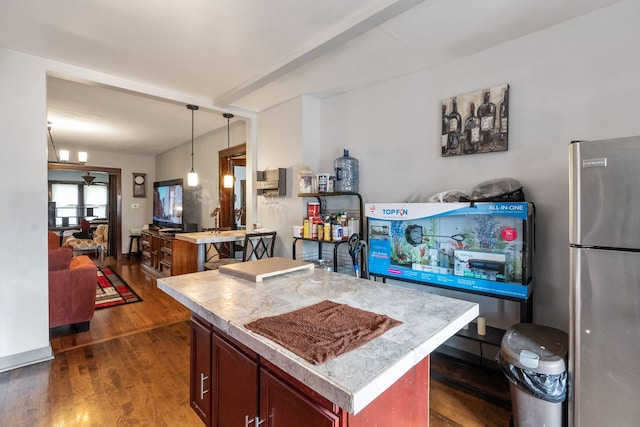 4109 W Oakdale Ave, Chicago, IL 60641 - kitchen featuring freestanding refrigerator, dark wood-style floors, hanging light fixtures, light countertops, and open floor plan
