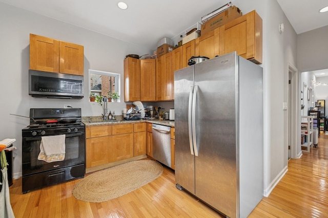 3430 S Parnell Ave, Chicago, IL 60616 - kitchen featuring stainless steel appliances, light wood-style floors, a sink, light stone countertops, and recessed lighting