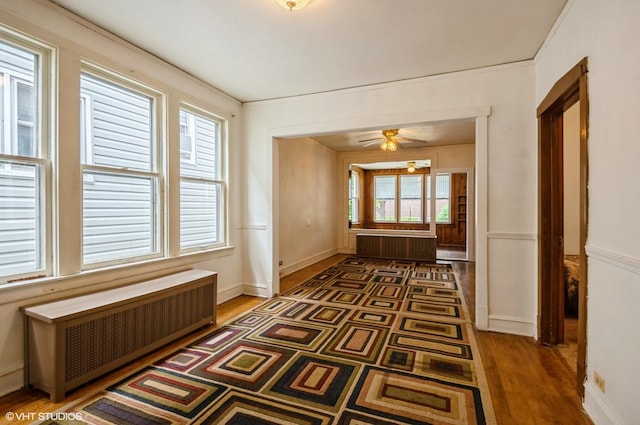 2109 N Long Ave, Chicago, IL 60639 - hall with radiator heating unit, wood finished floors, and baseboards