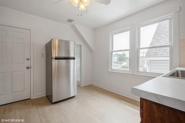 2109 N Long Ave, Chicago, IL 60639 - kitchen with freestanding refrigerator, a ceiling fan, baseboards, light wood finished floors, and light countertops