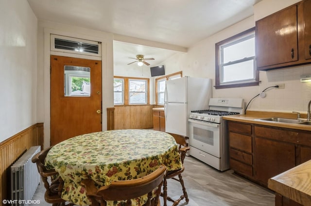 2109 N Long Ave, Chicago, IL 60639 - kitchen with white range with gas stovetop, radiator, a sink, light countertops, and ceiling fan