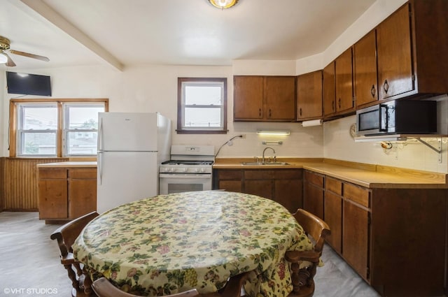 2109 N Long Ave, Chicago, IL 60639 - kitchen with white appliances, light countertops, a sink, tasteful backsplash, and a ceiling fan