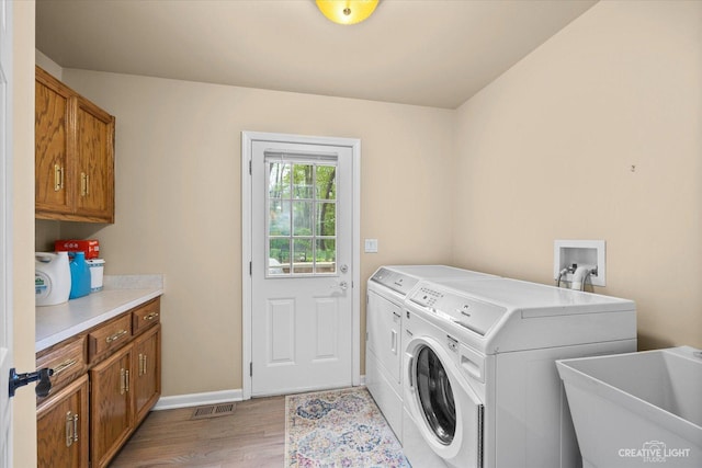 440 Cranesbill Dr, West Chicago, IL 60185 - laundry room with cabinet space, washer and clothes dryer, light wood-style floors, and baseboards