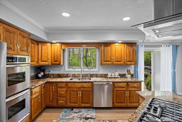 440 Cranesbill Dr, West Chicago, IL 60185 - kitchen featuring stainless steel appliances, a sink, ornamental molding, brown cabinets, and recessed lighting
