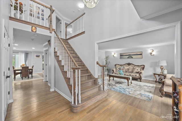 440 Cranesbill Dr, West Chicago, IL 60185 - staircase featuring wood finished floors, crown molding, baseboards, and a high ceiling