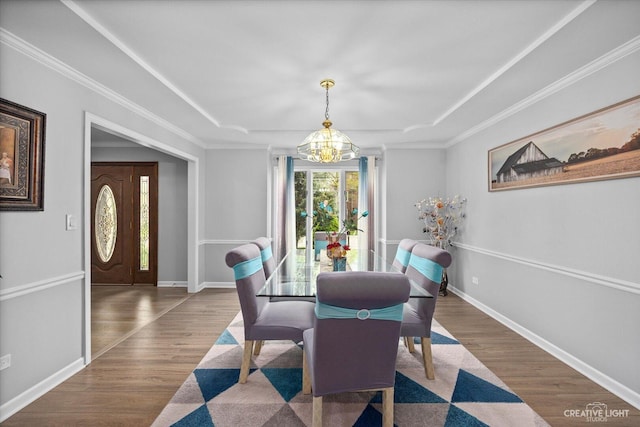 440 Cranesbill Dr, West Chicago, IL 60185 - dining space with a chandelier, wood finished floors, a raised ceiling, baseboards, and crown molding