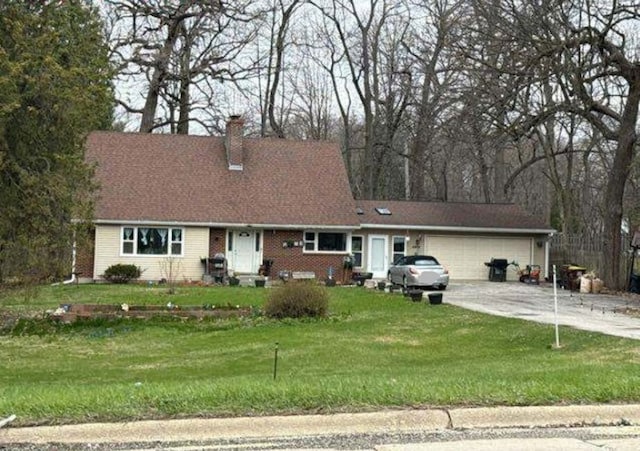 4814 Spring Creek Rd, Rockford, IL 61114 - view of front of home featuring an attached garage, a chimney, concrete driveway, and a front yard