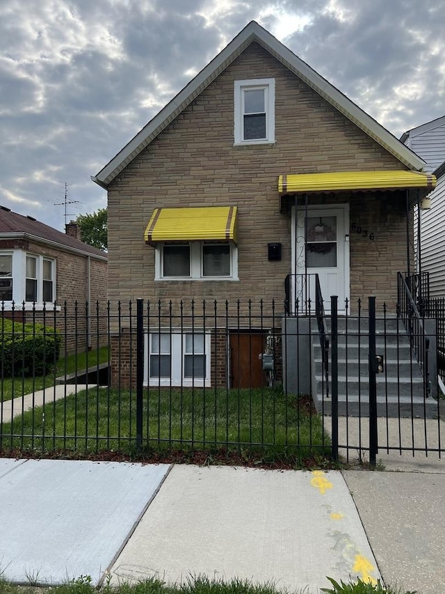6036 S Loomis Blvd, Chicago, IL 60636 - view of front facade featuring stone siding and a fenced front yard