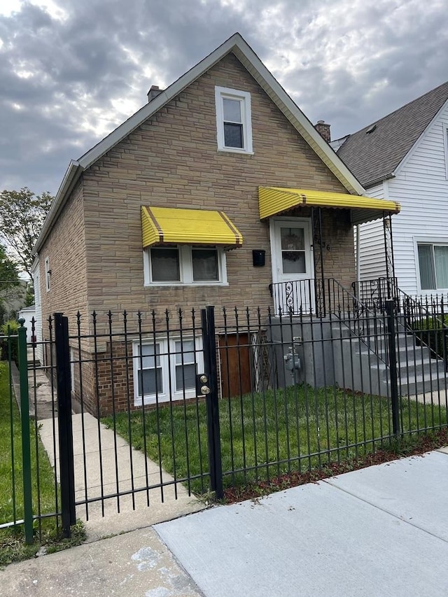 6036 S Loomis Blvd, Chicago, IL 60636 - view of front of home featuring a fenced front yard, brick siding, a chimney, and stone siding
