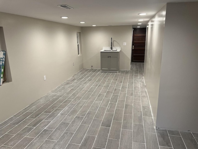 6036 S Loomis Blvd, Chicago, IL 60636 - empty room with wood finished floors, recessed lighting, and a sink