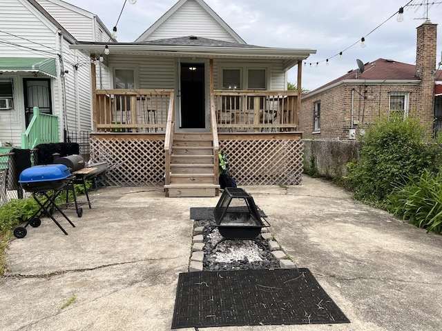 6036 S Loomis Blvd, Chicago, IL 60636 - back of property with an outdoor fire pit, a porch, and stairs