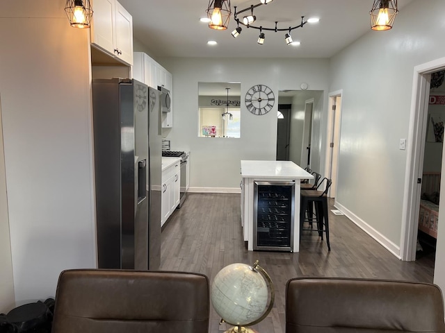6036 S Loomis Blvd, Chicago, IL 60636 - kitchen featuring beverage cooler, stainless steel appliances, a kitchen island, and white cabinetry