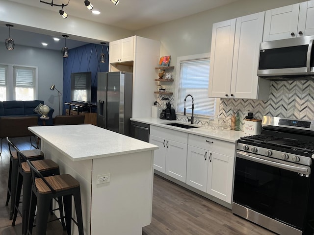 6036 S Loomis Blvd, Chicago, IL 60636 - kitchen featuring stainless steel appliances, plenty of natural light, a sink, backsplash, and recessed lighting