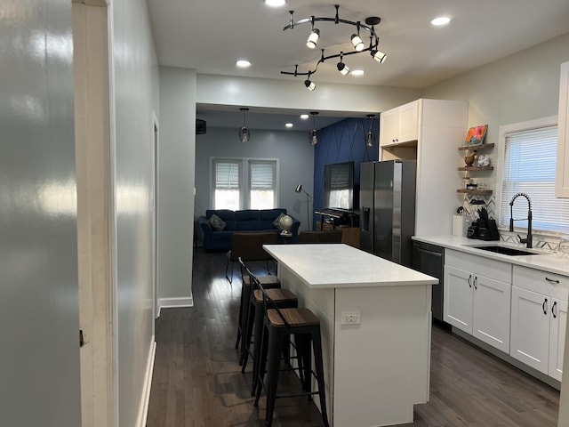 6036 S Loomis Blvd, Chicago, IL 60636 - kitchen with stainless steel refrigerator with ice dispenser, dishwasher, dark wood-style floors, a kitchen island, and a kitchen breakfast bar