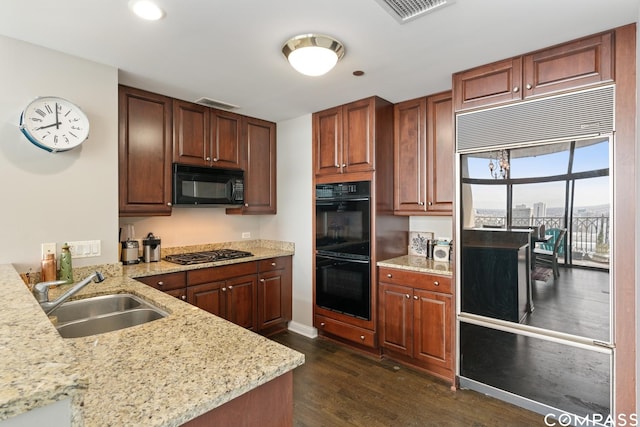 21 E Huron St Unit 3301, Chicago, IL 60611 - kitchen featuring black appliances, dark wood-style flooring, light stone countertops, and recessed lighting