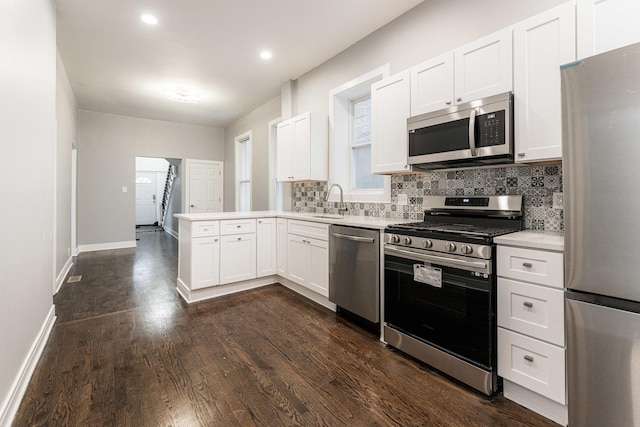 3216 W Walnut St, Chicago, IL 60624 - kitchen featuring stainless steel appliances, a peninsula, a sink, light countertops, and backsplash