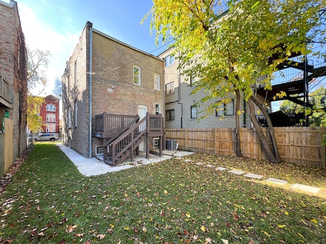 3216 W Walnut St, Chicago, IL 60624 - rear view of property with stairs, a wooden deck, brick siding, and central air condition unit