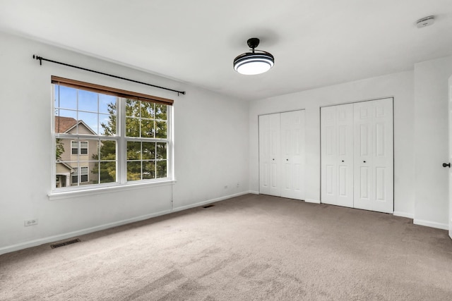 1544 Sauganash Ct, Gurnee, IL 60031 - unfurnished bedroom with multiple closets, carpet floors, and baseboards