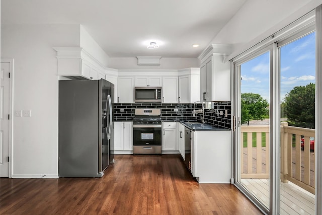 1544 Sauganash Ct, Gurnee, IL 60031 - kitchen featuring appliances with stainless steel finishes, dark countertops, decorative backsplash, white cabinets, and dark wood-type flooring