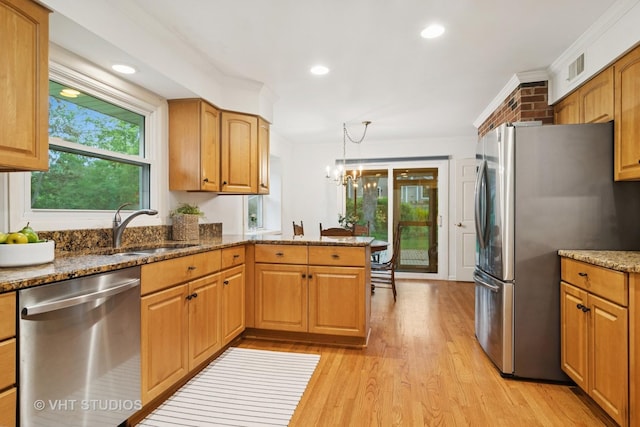 1116 W Mallard Dr, Palatine, IL 60067 - kitchen with stainless steel appliances, a sink, light wood-style flooring, dark stone counters, and a chandelier