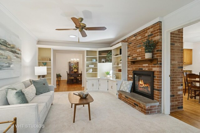 1116 W Mallard Dr, Palatine, IL 60067 - living room with ornamental molding, a ceiling fan, a brick fireplace, light wood finished floors, and a chandelier