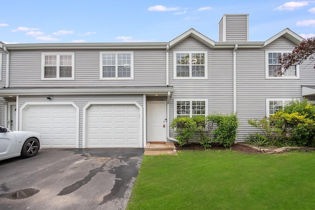 1991 Westview Ln, Round Lake Beach, IL 60073 - multi unit property featuring a front lawn, driveway, an attached garage, and a chimney