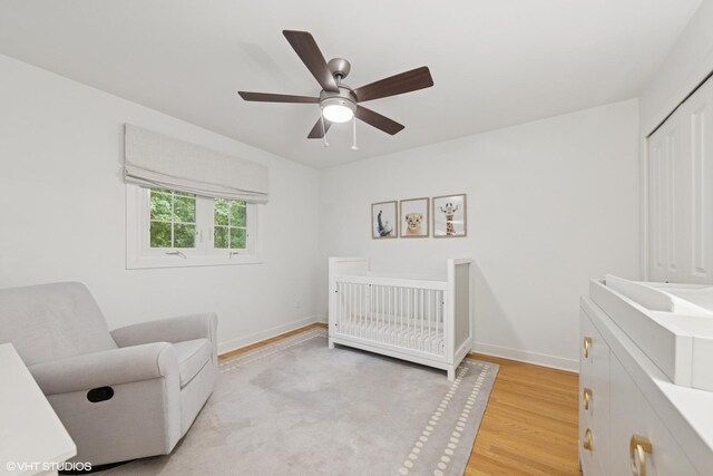 5104 Johnson Ave, Western Springs, IL 60558 - bedroom with baseboards, light wood-type flooring, a nursery area, a closet, and a ceiling fan