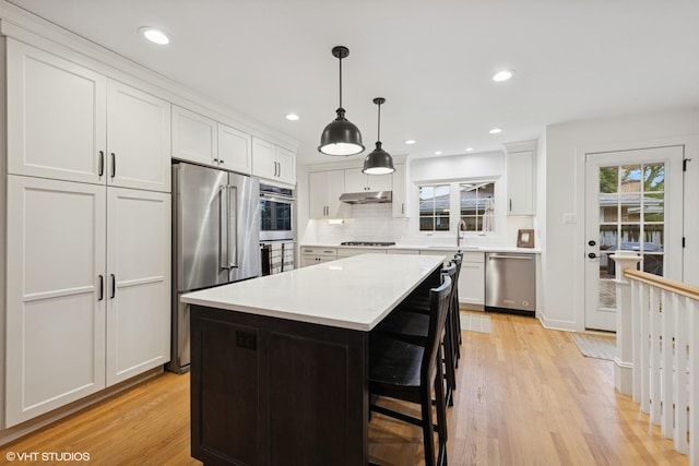5104 Johnson Ave, Western Springs, IL 60558 - kitchen with stainless steel appliances, light wood finished floors, backsplash, white cabinets, and recessed lighting